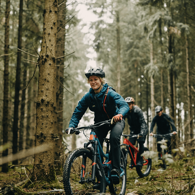 Image of a women and few other people riding a bicycle 